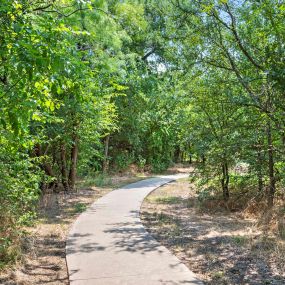 Walking trail connected to the community surrounded by wooded greenspace