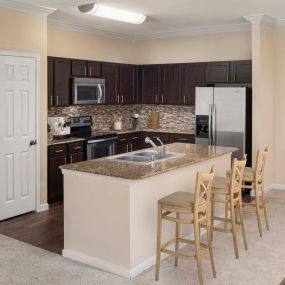 Vista style kitchen with granite countertops crown molding and stainless steel appliances