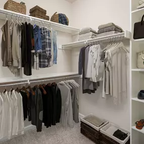 Walk-in closet with built-in wood shelves and racks at Camden Riverwalk apartments in Grapevine, TX