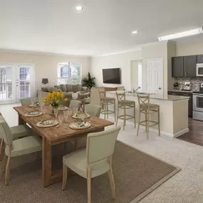 Vista style open concept dining and living room with french doors to balcony carpet and wood look floors