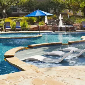 Resort style pool with lounge chairs