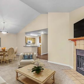 Living and dining room with carpet and fireplace