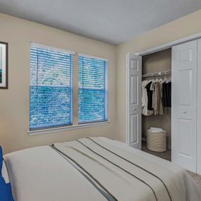 Bedroom with carpet and closet with folding doors