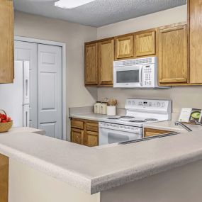 Kitchen with laminate countertops and white appliances