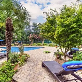 pool with lounge chairs and beautiful landscaping