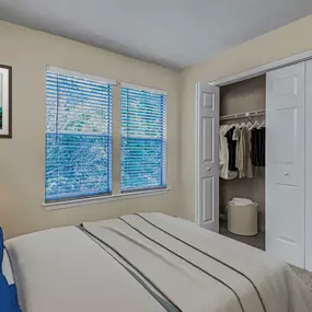 Bedroom with carpet and closet with folding doors