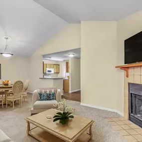 Living and dining room with carpet and fireplace