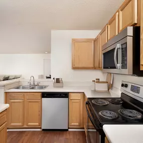 Kitchen with stainless steel appliances and upgraded lighting at Camden Touchstone in Charlotte, NC
