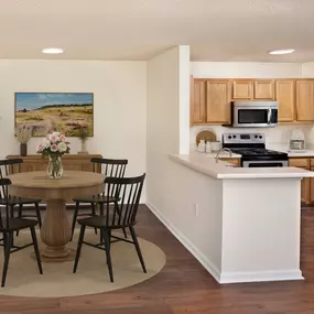 Upgraded lighting in dining and adjacent kitchen at Camden Touchstone in Charlotte, NC