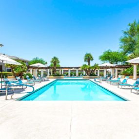 Swimming pool with deck chairs