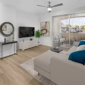 Camden San Marcos Apartments Scottsdale AZ open concept living room with woodlike flooring near covered patio