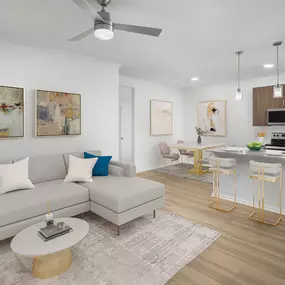 Camden San Marcos Apartments Scottsdale AZ open-concept living room near dining area and kitchen with stainless steel appliances, white quartz countertops with space for barstool seating