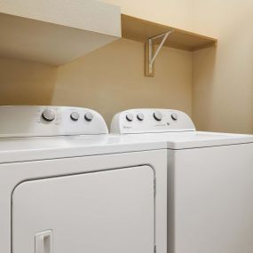Laundry with side by side washer dryer and shelf