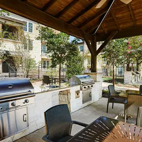 Outdoor cabana lounge area with grills and seating