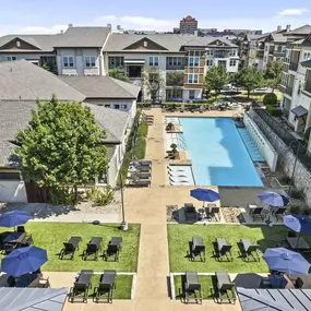 Resort-style pool and poolside yard lounge at Camden La Frontera apartments in Round Rock, TX