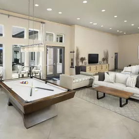 Clubroom pool table and lounge area at Camden La Frontera apartments in Austin, TX