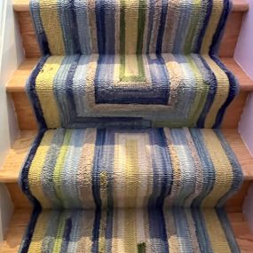 An ordinary rug turned into a stair runner.