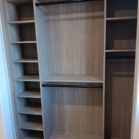 Organize your life with this custom reach in closet finished with toasted oak