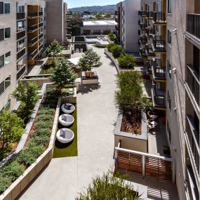 Exterior resident lounge areas with seating and landscaped walkways