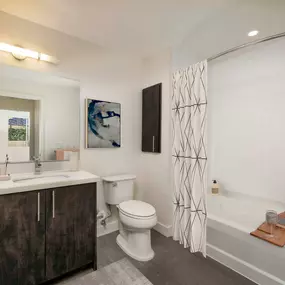 Luxury bathroom with brushed nickel fixures and white quartz countertops