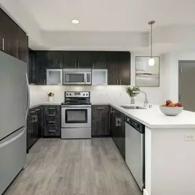 Luxury kitchen with stainless steel appliances and white quartz countertops