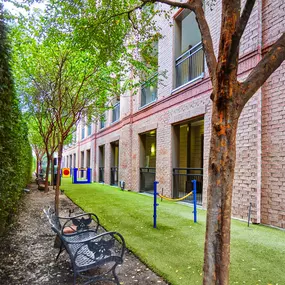 Fenced dog run with obstacle equipment at Camden Plaza Apartments in Houston, TX