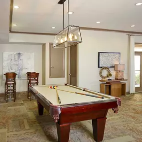 Resident game room with billiards and bar stools at Camden Plaza Apartments in Houston, TX