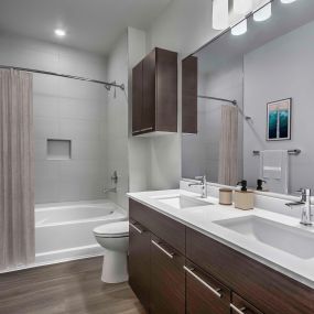 Bathroom with dual vanity sinks and soaking tub