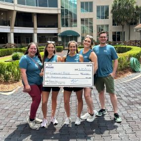 Agents Melissa Roberts and Tiffany Turlich and their staff, with a $10,000 donation check for Covenant House made through the Good Hands Foundation!