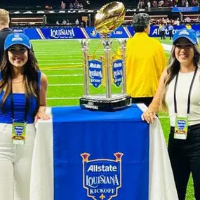 Melissa and Tiffany presenting the trophy at the Allstate Sugar Bowl Kickoff game.