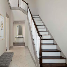 Townhome entry way with staircase to second level and tile flooring