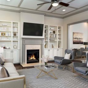 Townhome living room with hardwood flooring, built-in shelving, and high ceilings with ceiling fan