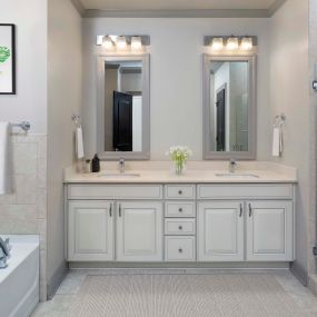 Townhome bathroom with walk-in shower, soaking tub, and dual vanity