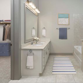 Tower bathroom with walk-in closet, walk-in shower, and soaking tub.