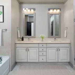 Townhome bathroom with walk-in shower, soaking tub, and dual vanity