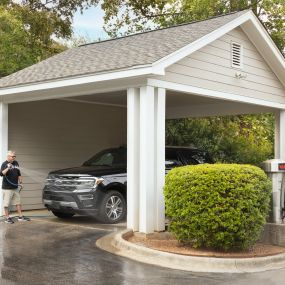 Outdoor, covered car wash at Camden Lake Pine apartments located in Raleigh, NC.