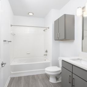 Bathroom with quartz countertops and cabinet storage at Camden Westchase Park apartments in Tampa, Florida.