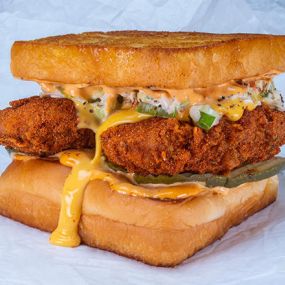 THE CHEESY CHICK - two crispy fried chicken tenders, spiced to your liking (plain, nashville hot or nashville hotter) with dill pickles, slaw, white american cheese, and chipotle aioli; served on kings hawaiian rolls