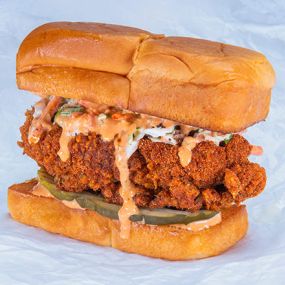 THE HOT CHICK SLIDER - crispy fried chicken tender, spiced to your liking (plain, nashville hot or nashville hotter) with secret sauce, dill pickle slices and slaw; served on kings hawaiian rolls