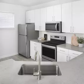 Kitchen with modern finishes at Camden Dunwoody Apartments in Dunwoody, GA