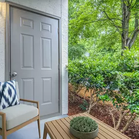 Private patio with storage closet surrounded by lush greenery