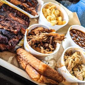 Our Meat Sampler is packed full of flavor with mouth-watering meats and signature sides.