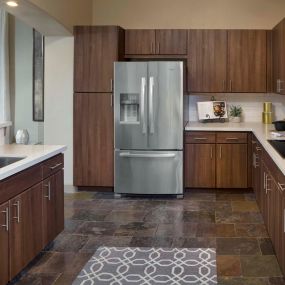 Kitchen with quartz countertops double ovens tile flooring and stainless steel appliances