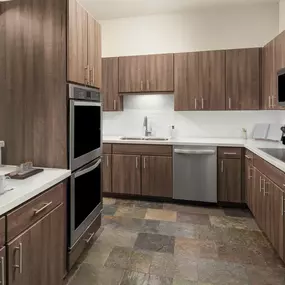 Luxury kitchen with stainless steel appliances and double oven at Camden Post Oak high-rise apartment homes in Houston, TX