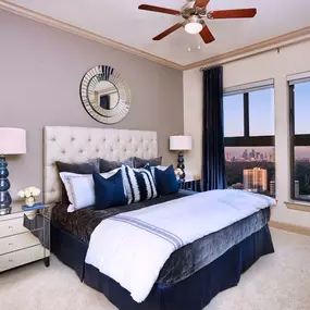 Bedroom with crown molding carpet flooring high ceilings and ceiling fan