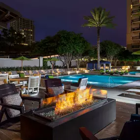 Poolside firepit and seating at night