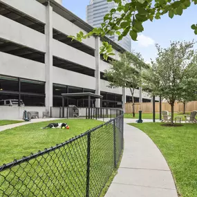 Onsite private dog park with seating at Camden Post Oak Apartments in Houston, TX