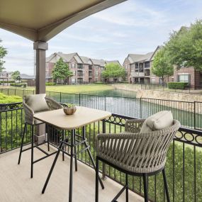 Private patio overlooking community lake at Camden Panther Creek apartments in Frisco, TX