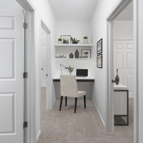 Hallway with built-in desk in three bedroom floor plan at Camden Panther Creek apartments in Frisco, TX