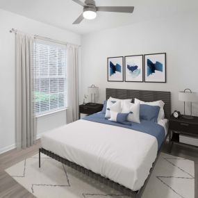 Bedroom with wood-style floors and built-in desk at Camden Panther Creek apartments in Frisco, TX